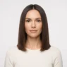 Woman with soft blunt collarbone-length haircut facing front under even studio lighting against white backdrop
